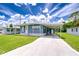 Inviting home showcasing a long driveway and carport that provides ample parking with a blue exterior at 35014 Carl Ave, Zephyrhills, FL 33541