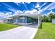 Lovely residence featuring a covered parking area, neat landscaping, and a serene atmosphere at 35014 Carl Ave, Zephyrhills, FL 33541