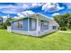 Delightful home with a clean exterior and porch, set against a backdrop of green grass at 35014 Carl Ave, Zephyrhills, FL 33541