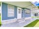 Inviting front porch with stylish accents and covered entrance at 35014 Carl Ave, Zephyrhills, FL 33541