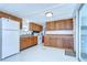 Well-lit kitchen with wood cabinetry and plenty of counter space at 35014 Carl Ave, Zephyrhills, FL 33541