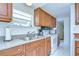 Galley-style kitchen featuring stainless appliances and wood cabinetry at 35014 Carl Ave, Zephyrhills, FL 33541