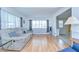 Inviting living room featuring hardwood floors and bright windows at 35014 Carl Ave, Zephyrhills, FL 33541