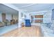 Spacious living room with wood flooring and views to kitchen and seating area at 35014 Carl Ave, Zephyrhills, FL 33541