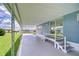 View of covered patio area; leads to yard with a pathway offering serene outdoor living at 35014 Carl Ave, Zephyrhills, FL 33541