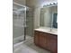 Bathroom featuring a glass-enclosed shower and vanity with modern fixtures and lighting at 3641 Parkridge Cir # 10-103, Sarasota, FL 34243