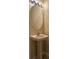 Pedestal sink and chrome faucet in a modern bathroom with an oval mirror at 3641 Parkridge Cir # 10-103, Sarasota, FL 34243