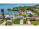 Aerial view of waterfront home with private dock and lush landscaping, near the water at 380 Colony Point S Rd, St Petersburg, FL 33705