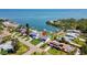 Gorgeous aerial view of a waterfront home with a sparkling pool and lush landscaping, in a charming coastal community at 380 Colony Point S Rd, St Petersburg, FL 33705