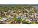 Stunning aerial view of a waterfront home with a private pool, lush landscaping, and a dock at 380 Colony Point S Rd, St Petersburg, FL 33705