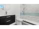 Modern bathroom featuring a marble-tiled shower with a unique light blue accent stripe at 380 Colony Point S Rd, St Petersburg, FL 33705