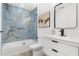 Stylish bathroom with blue tile shower, modern vanity, and framed mirror at 380 Colony Point S Rd, St Petersburg, FL 33705
