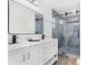 Bathroom with dual vanity, marble countertop, and glass-enclosed shower at 380 Colony Point S Rd, St Petersburg, FL 33705