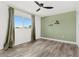 Clean bedroom with a ceiling fan, neutral decor and wood-look flooring at 380 Colony Point S Rd, St Petersburg, FL 33705