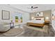 Sunlit bedroom featuring a wood bed frame and French doors leading to a balcony at 380 Colony Point S Rd, St Petersburg, FL 33705