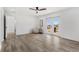 Bright bedroom featuring gray wood-look floors, a ceiling fan and French doors to a balcony at 380 Colony Point S Rd, St Petersburg, FL 33705