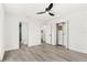 Open bedroom with a ceiling fan, hardwood floors, a closet and ensuite bathroom at 380 Colony Point S Rd, St Petersburg, FL 33705