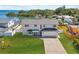 Stunning waterfront property featuring a modern two-story home with a lush lawn at 380 Colony Point S Rd, St Petersburg, FL 33705
