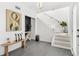 Bright foyer featuring light gray tile, a wooden bench, and a staircase at 380 Colony Point S Rd, St Petersburg, FL 33705