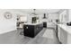 Bright, modern kitchen with black island, stainless steel appliances, and white cabinetry at 380 Colony Point S Rd, St Petersburg, FL 33705