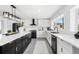 Bright kitchen with island, stainless steel appliances, white cabinets, and modern lighting at 380 Colony Point S Rd, St Petersburg, FL 33705