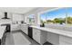 Modern kitchen featuring white cabinets, stainless steel appliances, and waterfront view at 380 Colony Point S Rd, St Petersburg, FL 33705
