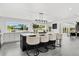 Spacious kitchen with a central island featuring seating, sleek countertops, and modern lighting fixtures, perfect for gatherings at 380 Colony Point S Rd, St Petersburg, FL 33705