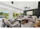 Bright living room boasts neutral tones, stylish furniture, and an inviting atmosphere, complemented by views of the backyard pool at 380 Colony Point S Rd, St Petersburg, FL 33705