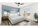 Bright main bedroom with a ceiling fan, white furnishings and a view to the outside balcony at 380 Colony Point S Rd, St Petersburg, FL 33705