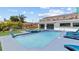 A stunning backyard pool and spa with a dolphin statue and private tanning deck offer outdoor relaxation at 380 Colony Point S Rd, St Petersburg, FL 33705