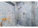 Luxurious shower with blue marble-look tile, recessed niche, and rainfall showerhead at 380 Colony Point S Rd, St Petersburg, FL 33705