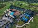Aerial view showcasing the tennis courts, pickleball courts, pool, and clubhouse at 4 Belleview Blvd # 305, Belleair, FL 33756
