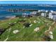 Stunning aerial view of the community golf course with waterfront condo buildings and city skyline at 4 Belleview Blvd # 305, Belleair, FL 33756