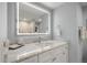 Updated bathroom with a marble countertop, vanity, and a modern, illuminated mirror at 4 Belleview Blvd # 305, Belleair, FL 33756