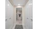 Hallway with access to the bathroom, closet, featuring neutral decor and tile flooring at 4 Belleview Blvd # 305, Belleair, FL 33756