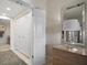 Hallway with access to the bathroom, closet, and a bedroom, featuring neutral decor at 4 Belleview Blvd # 305, Belleair, FL 33756