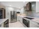Contemporary kitchen featuring stainless steel appliances and sleek white cabinetry at 4 Belleview Blvd # 305, Belleair, FL 33756