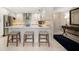 Modern kitchen with stainless steel appliances, white cabinetry, and bar seating at 4 Belleview Blvd # 305, Belleair, FL 33756