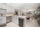 Open-concept kitchen with stainless appliances, wine storage, and view of the living area at 4 Belleview Blvd # 305, Belleair, FL 33756