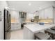Stylish kitchen with stainless steel appliances, white cabinets, and a spacious island at 4 Belleview Blvd # 305, Belleair, FL 33756