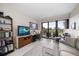 Bright living room features golf course views, comfortable seating, and access to a private balcony at 4 Belleview Blvd # 305, Belleair, FL 33756