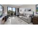 Bright living room features golf course views, comfortable seating, and access to a private balcony at 4 Belleview Blvd # 305, Belleair, FL 33756