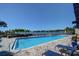 Community pool overlooking the Intracoastal with lounge chairs and beautiful landscaping at 4 Belleview Blvd # 305, Belleair, FL 33756