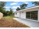 A partially landscaped backyard features a sliding glass door and sunny skies at 4020 N Falkenburg Rd, Tampa, FL 33610