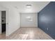 Bright bedroom with wood-look tile flooring and modern design, featuring a navy accent wall at 4020 N Falkenburg Rd, Tampa, FL 33610