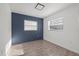 Bright bedroom with tile flooring and a navy accent wall; naturally lit by two windows at 4020 N Falkenburg Rd, Tampa, FL 33610