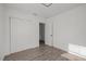 A bright, minimalist bedroom features a closet and light wood-look floors at 4020 N Falkenburg Rd, Tampa, FL 33610