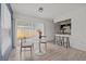 Sunlit dining area featuring tile floors, modern lighting, and easy access to the kitchen and living spaces at 4020 N Falkenburg Rd, Tampa, FL 33610
