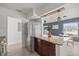 Kitchen island featuring granite countertop, stainless steel appliances, and modern pendant lighting at 4020 N Falkenburg Rd, Tampa, FL 33610