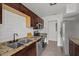 This bright kitchen has subway tile backsplash and dark wood cabinets that complement the granite countertops at 4020 N Falkenburg Rd, Tampa, FL 33610